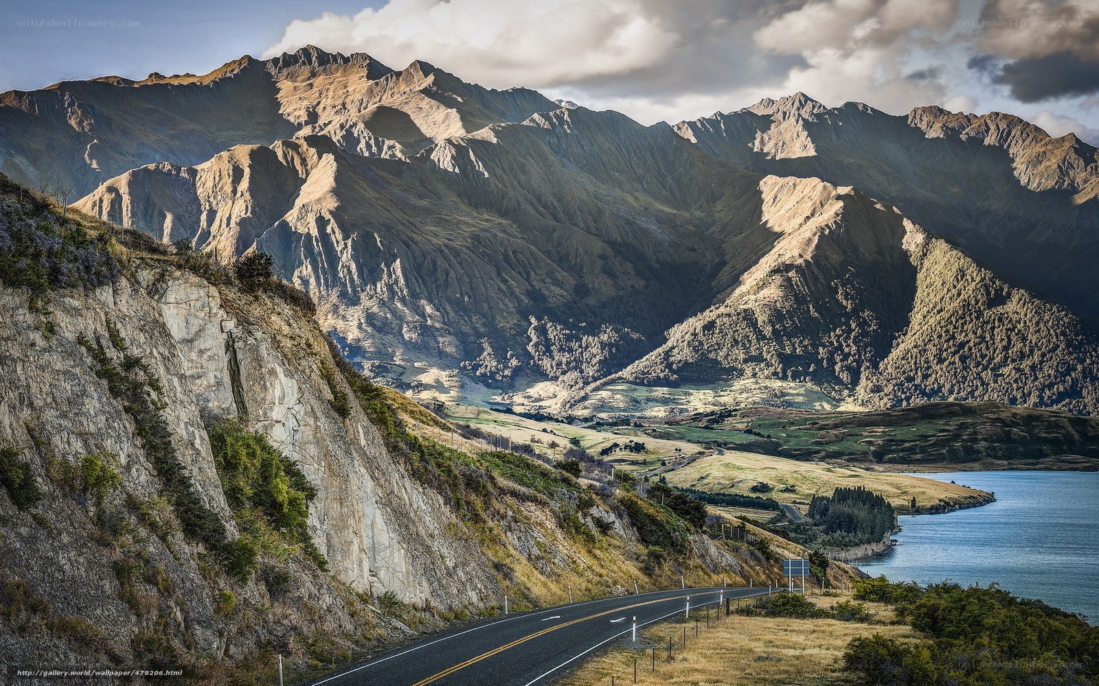 Mountain road by a lake