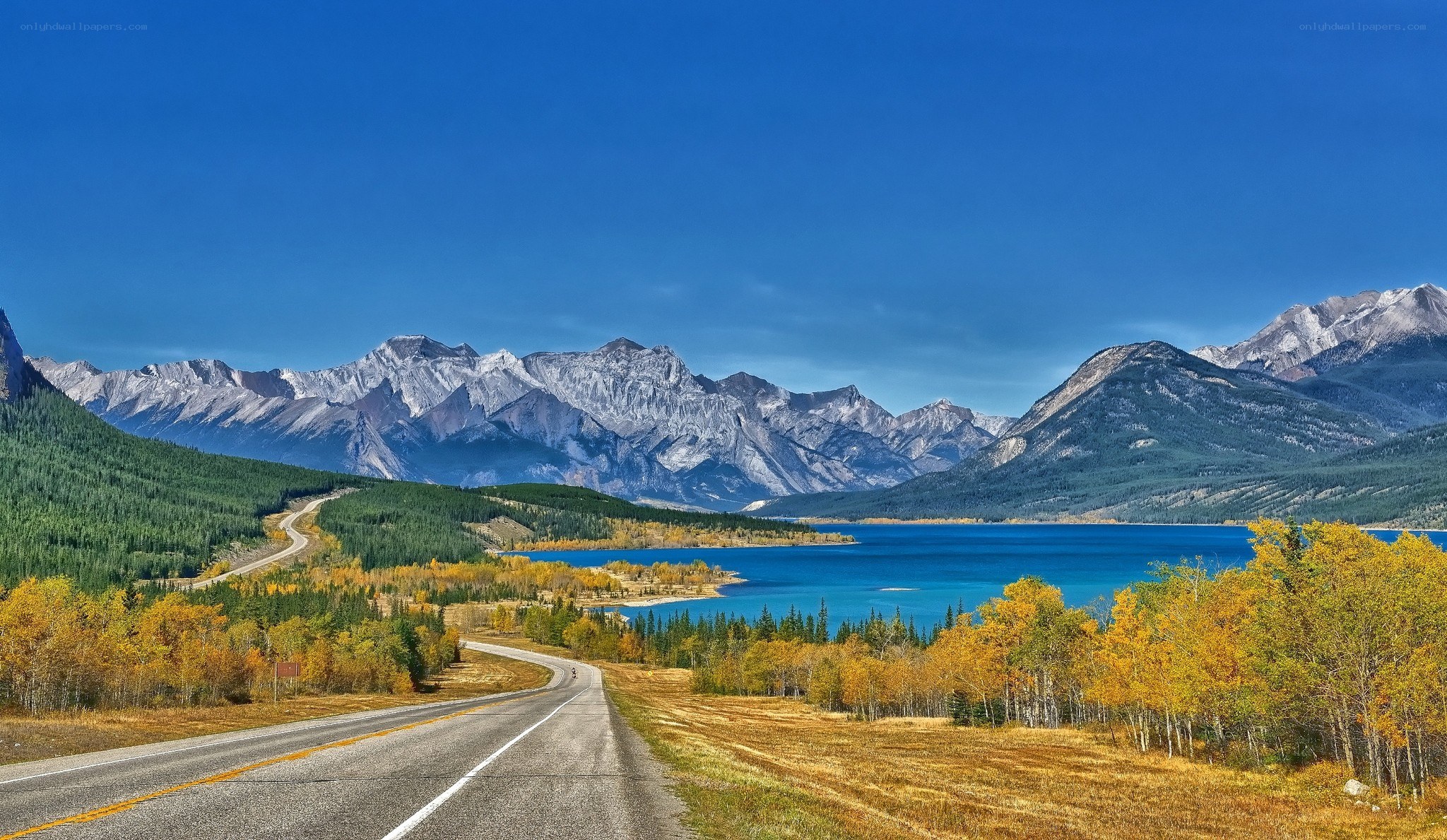 Mountain road by a lake