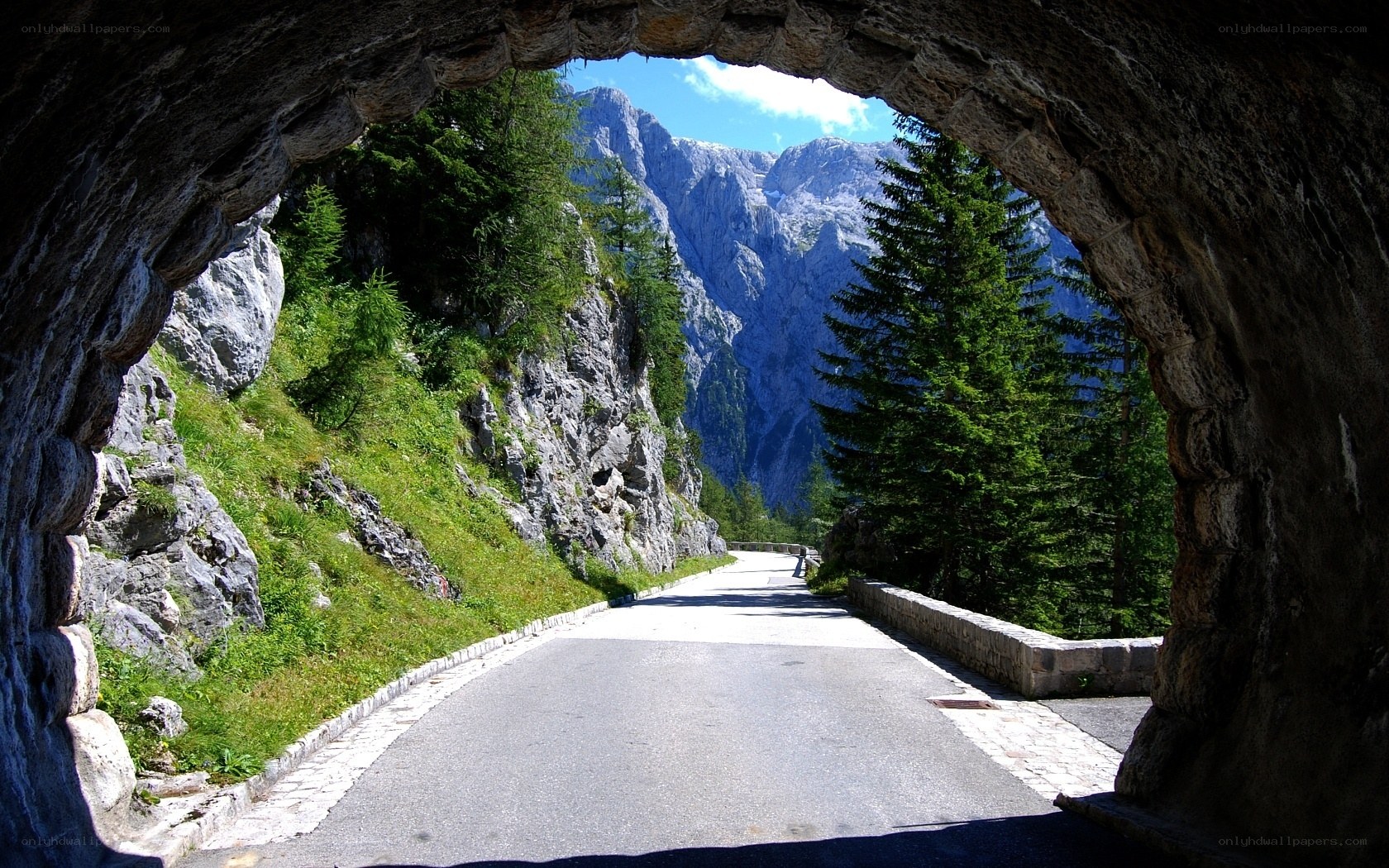 Mountain road through stone tunnel