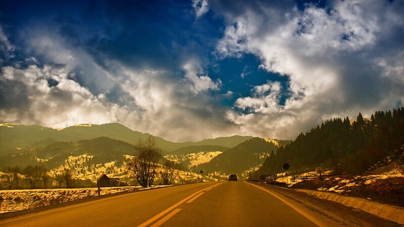 Mountain road under dramatic sky