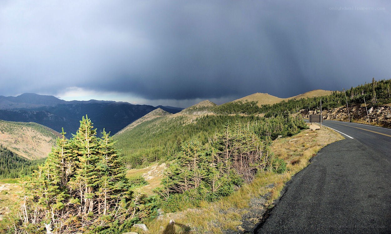 Mountain road under stormy sky
