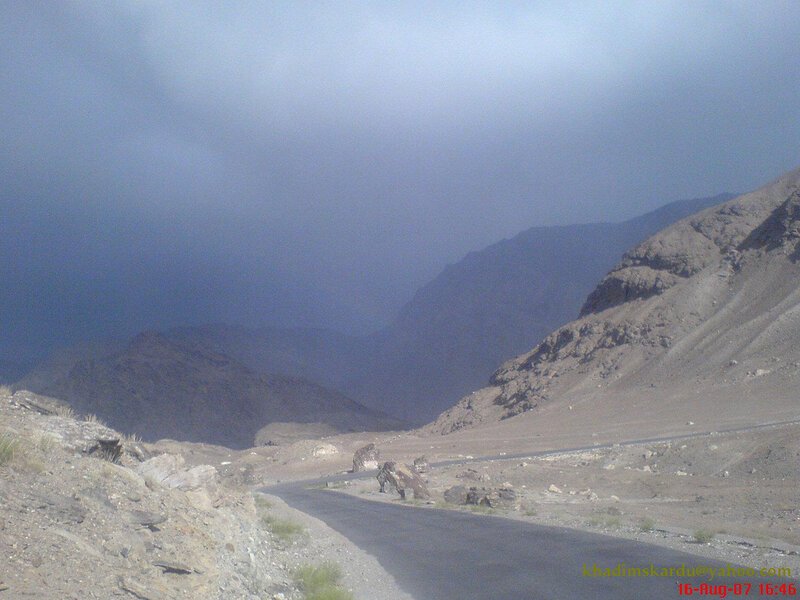 Mountain road under stormy sky