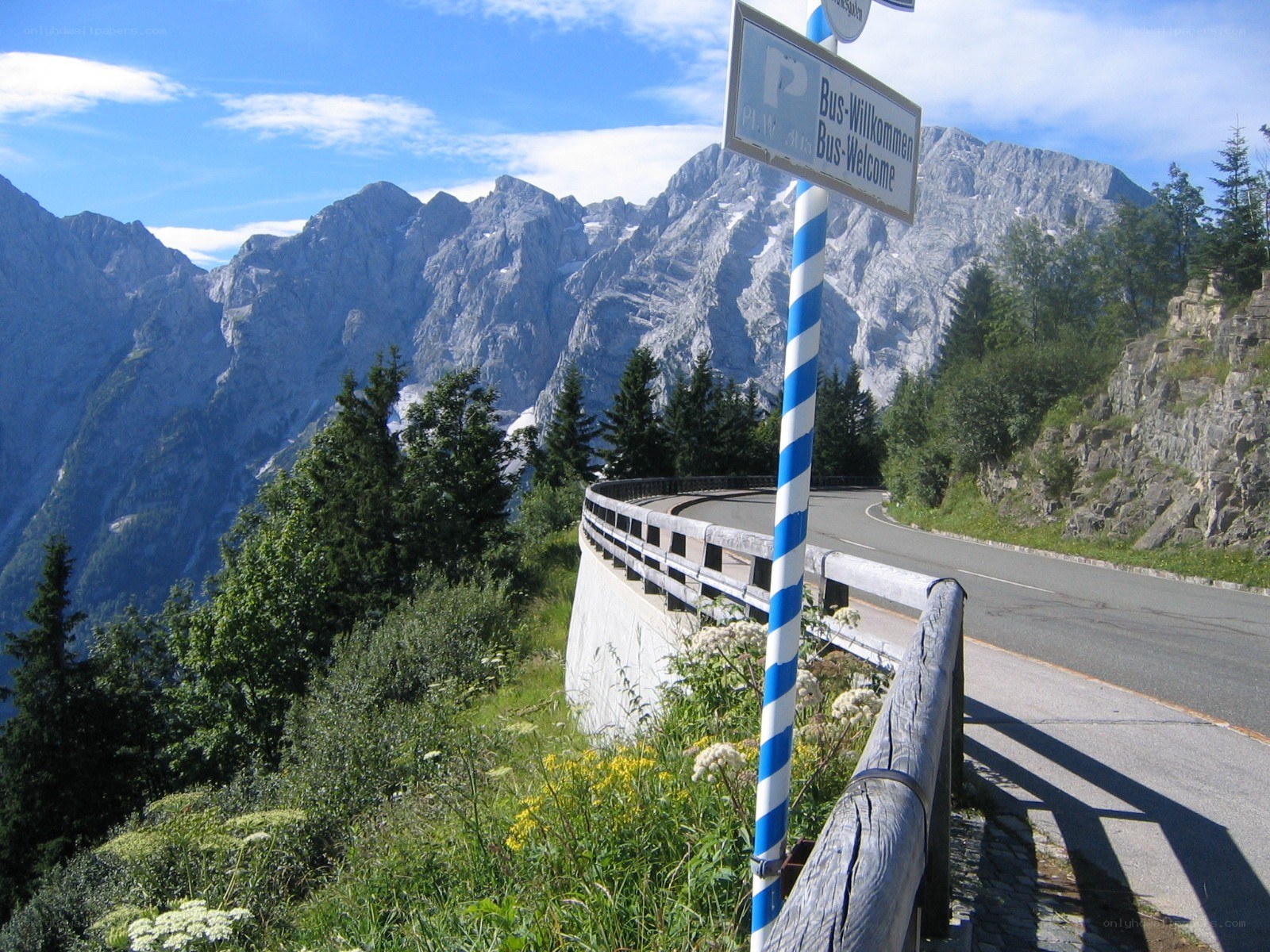 Mountain road with bus welcome sign