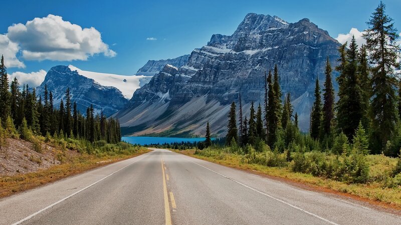 Mountain road with lake and peaks
