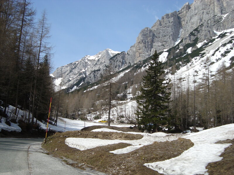 Mountain road with snow patches