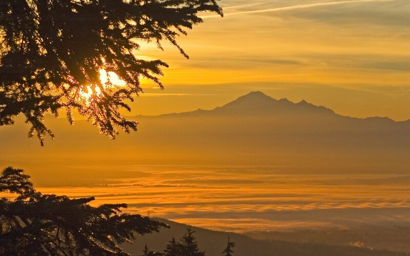 Mountain Silhouette at Sunrise — Orange, Serene, Photograph, Tree Branches, Clouds