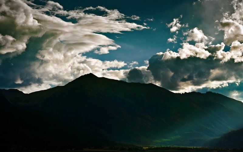 Mountain Silhouette under Clouds