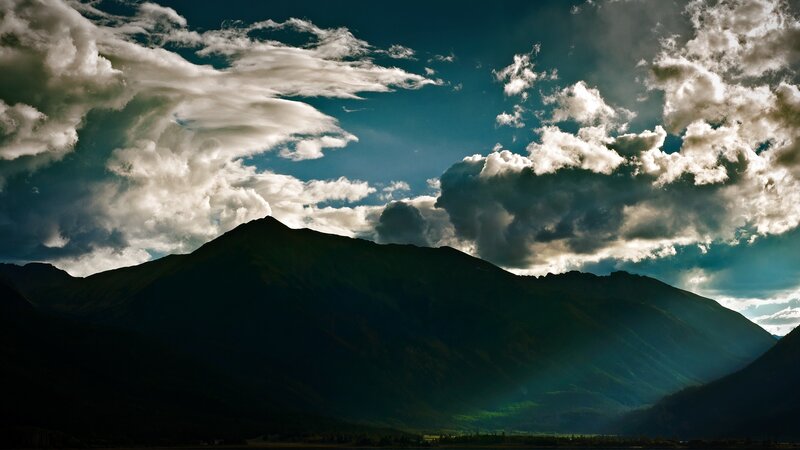 Mountain silhouette under dramatic clouds