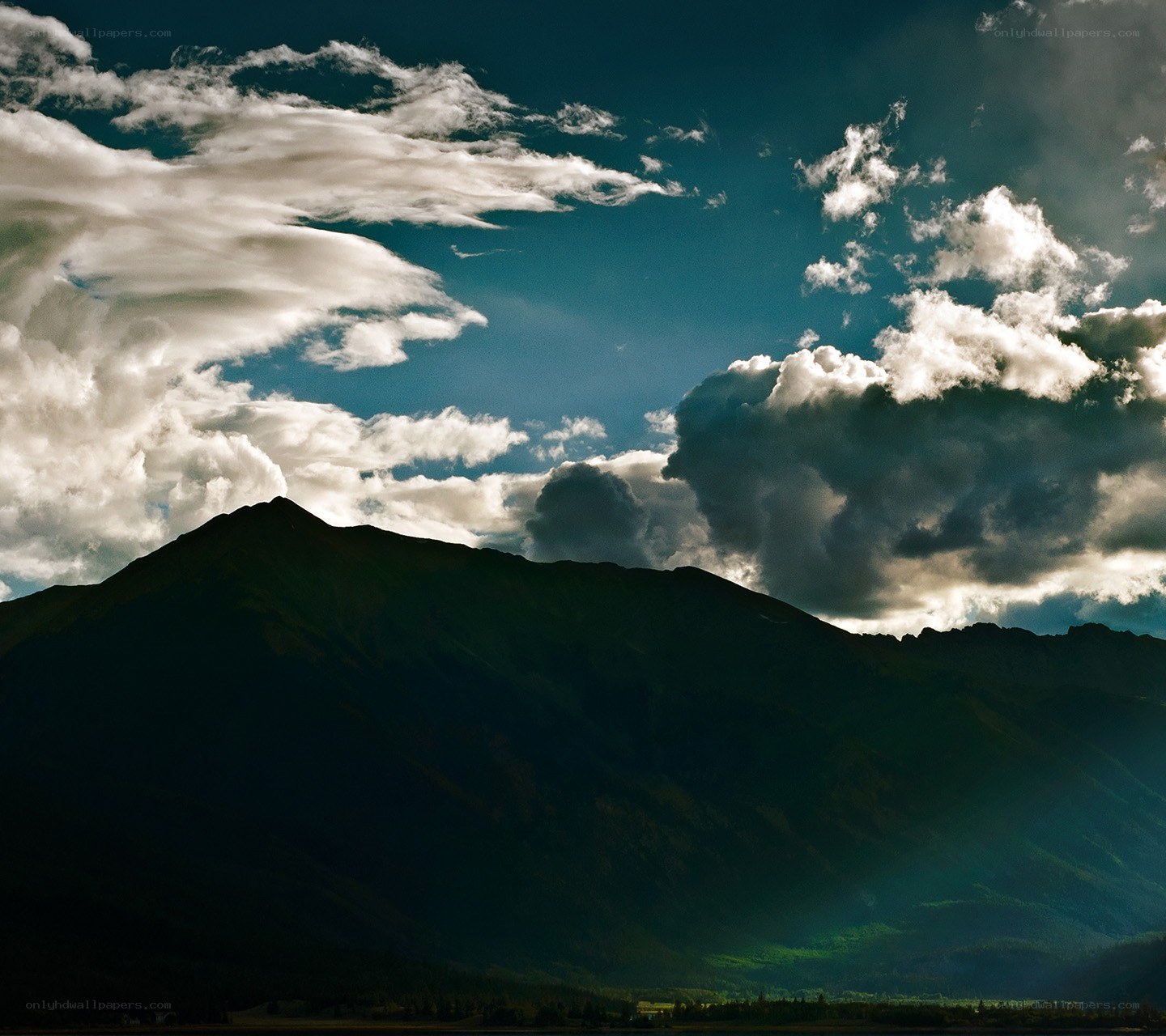 Mountain silhouette under dramatic clouds