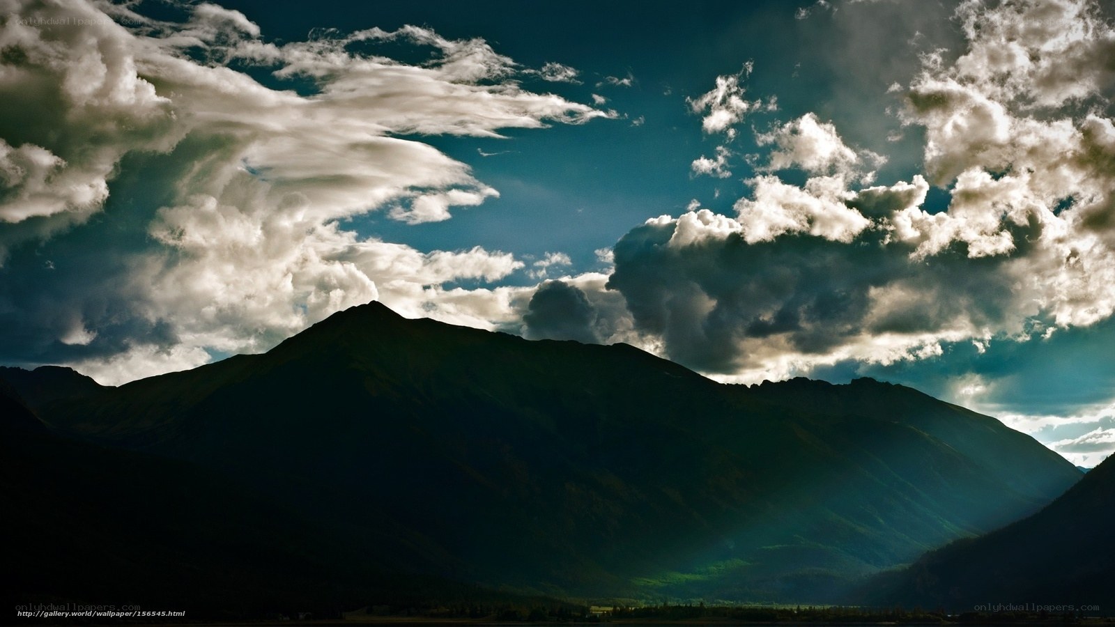 Mountain silhouette under dramatic clouds