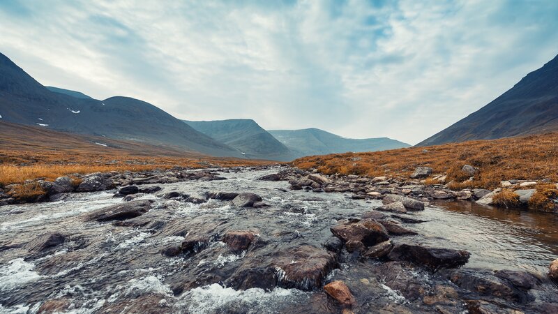 Mountain Stream Flowing over Rocks — Brown
