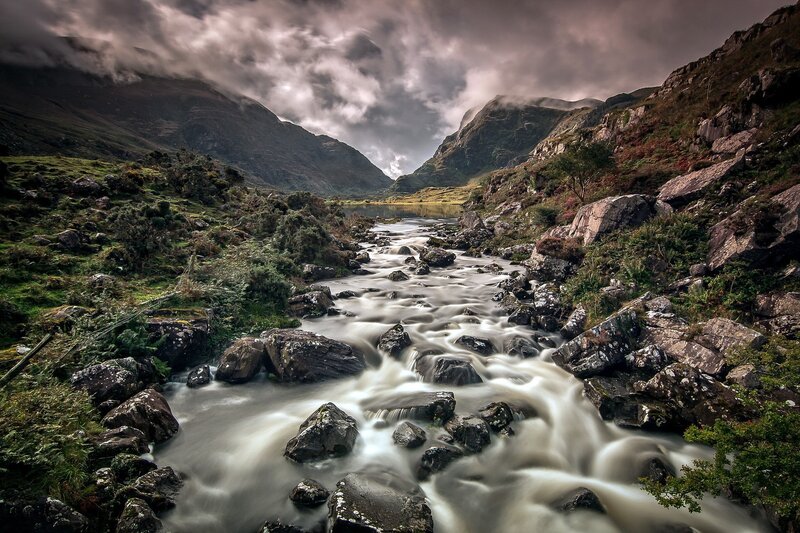 Mountain stream flowing through valley