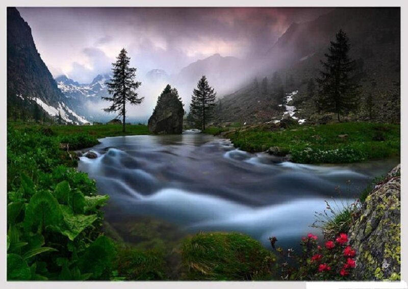 Mountain stream in misty valley