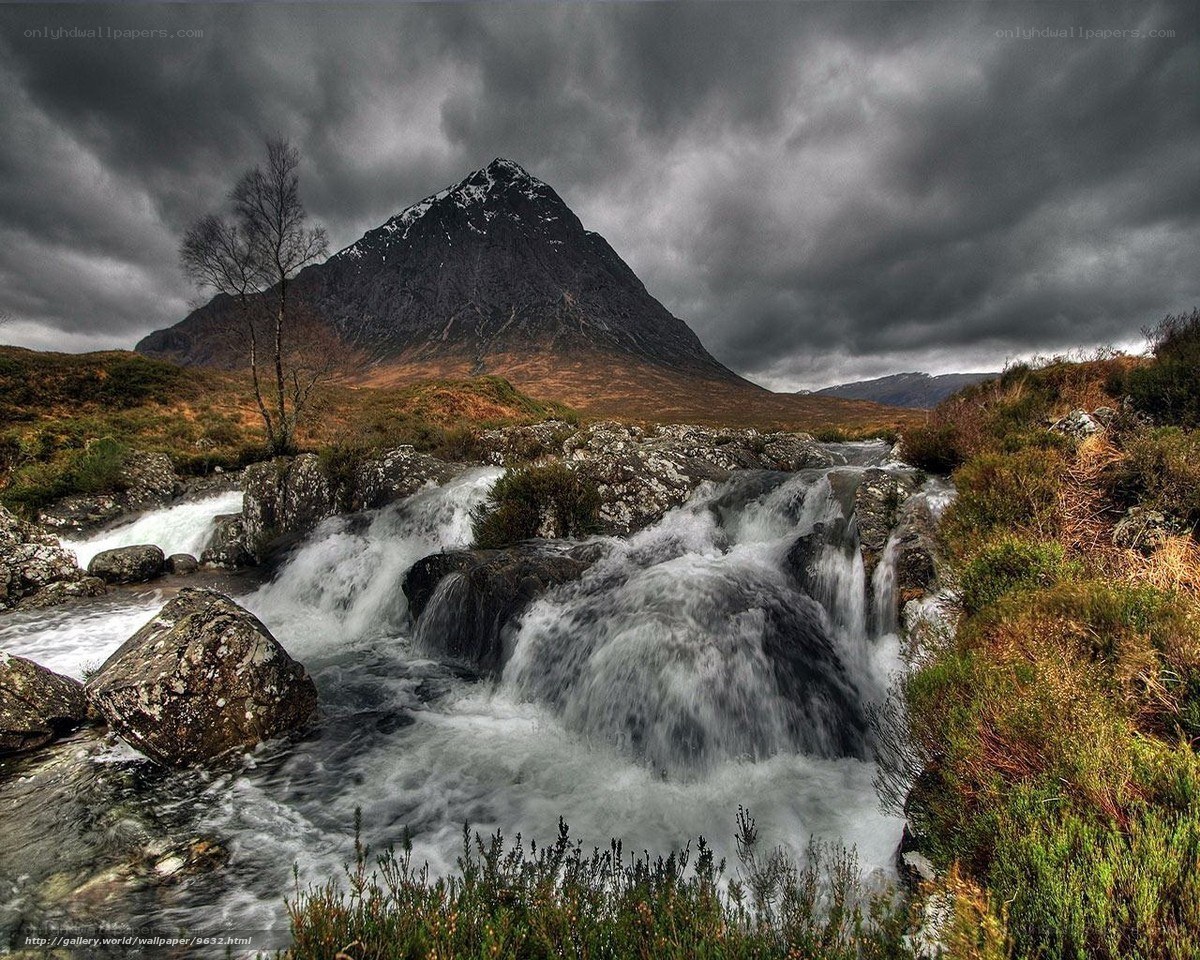 Mountain stream under stormy sky