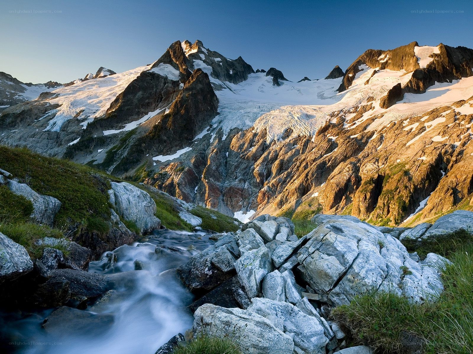 Mountain stream with snow-capped peaks
