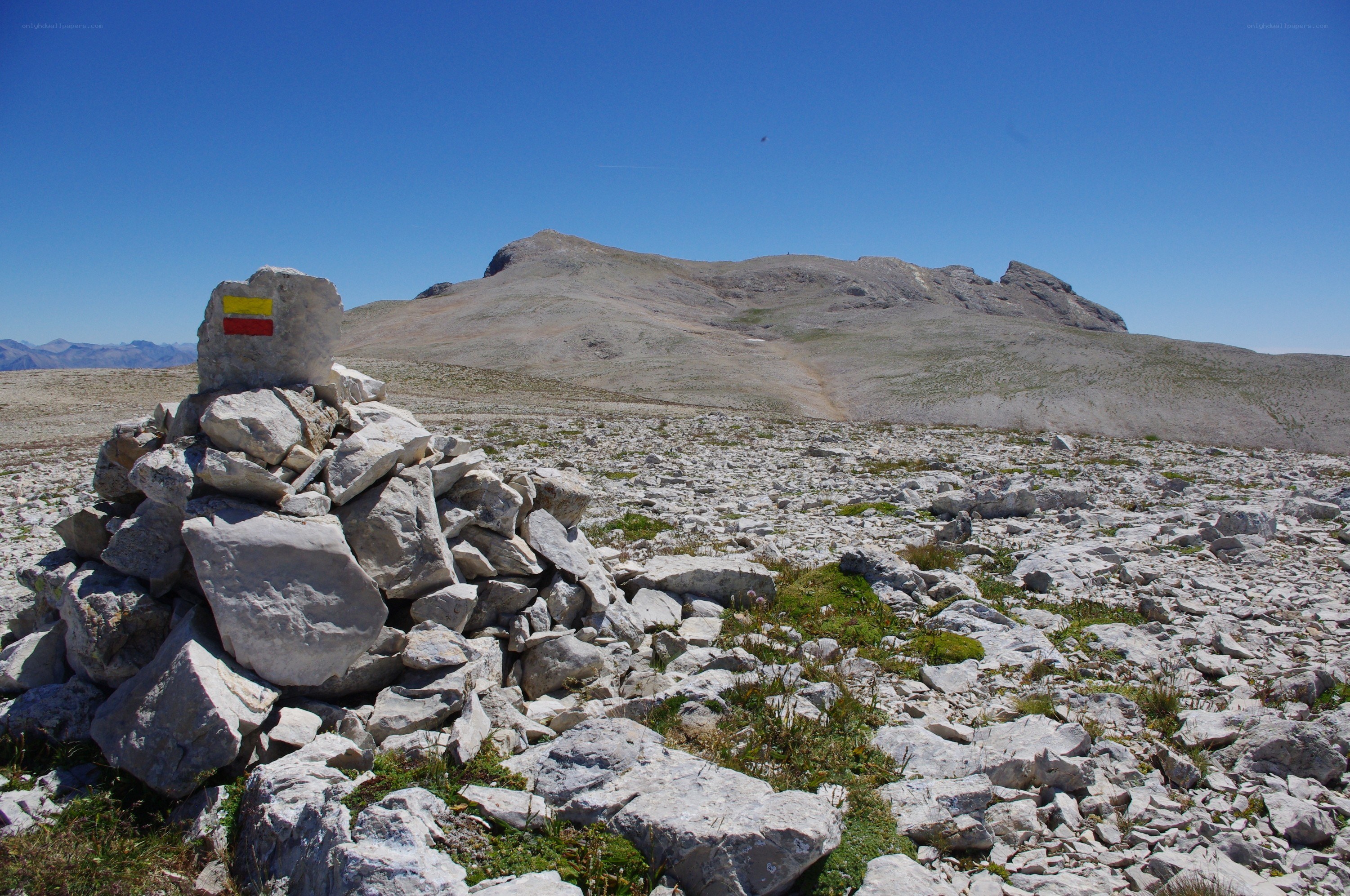 Mountain summit with trail marker