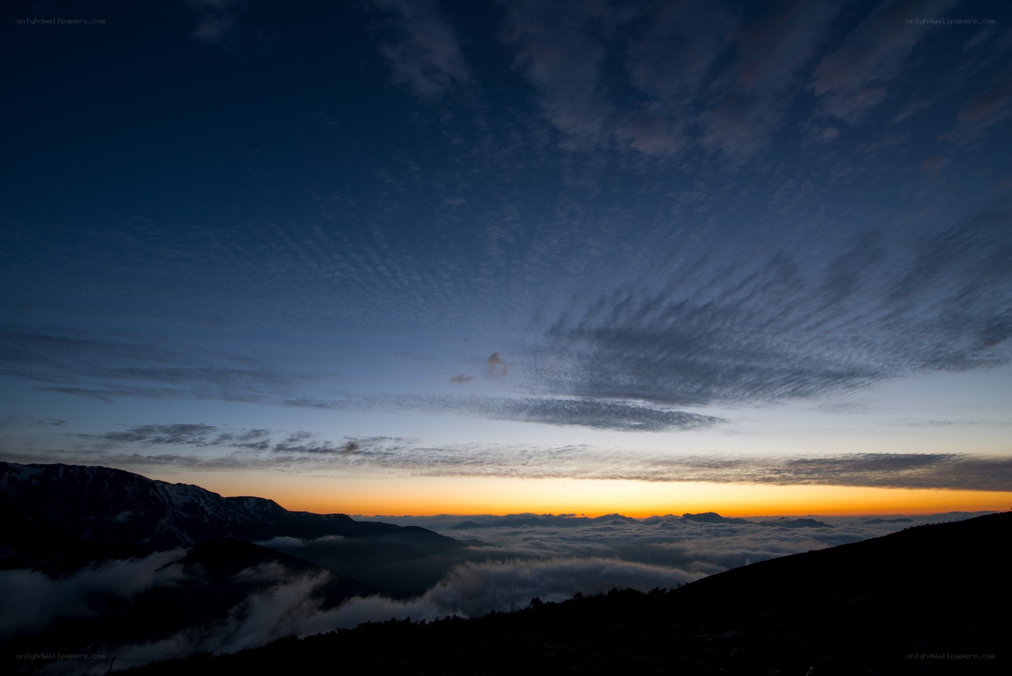 Mountain sunrise over clouds