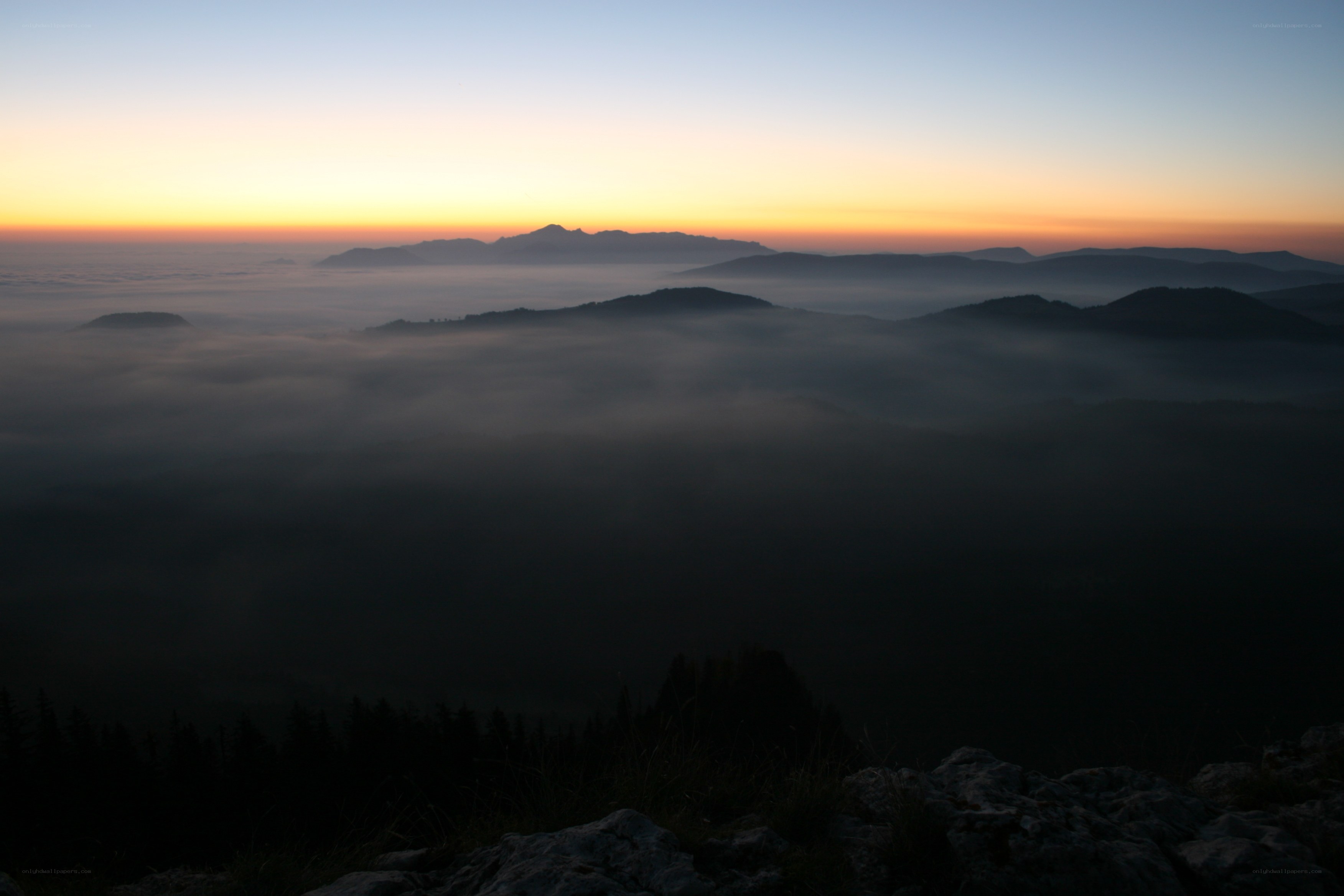 Mountain sunrise over fog