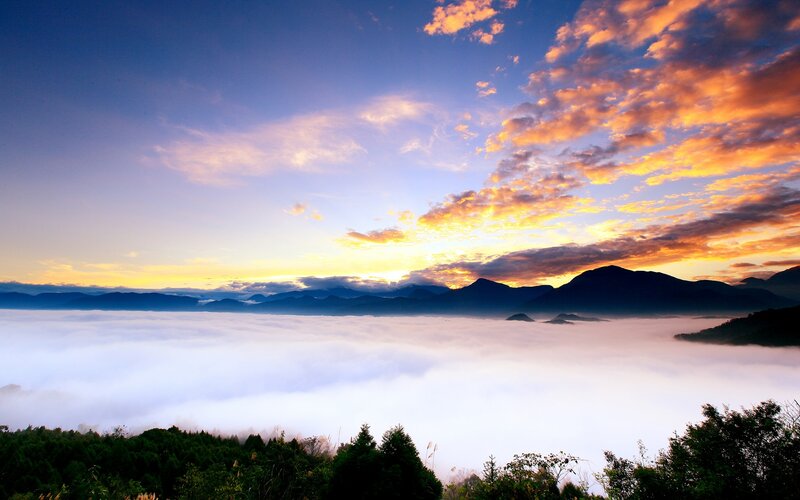 Mountain sunrise over sea of clouds