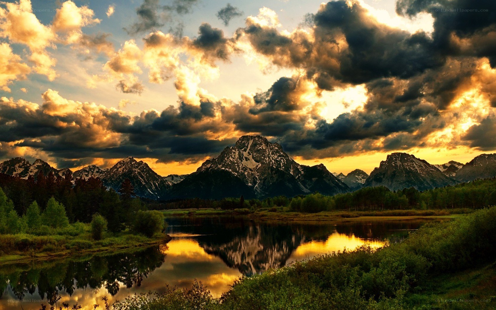 Mountain sunset over a calm lake