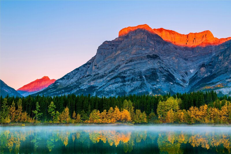 Mountain sunset over a calm lake