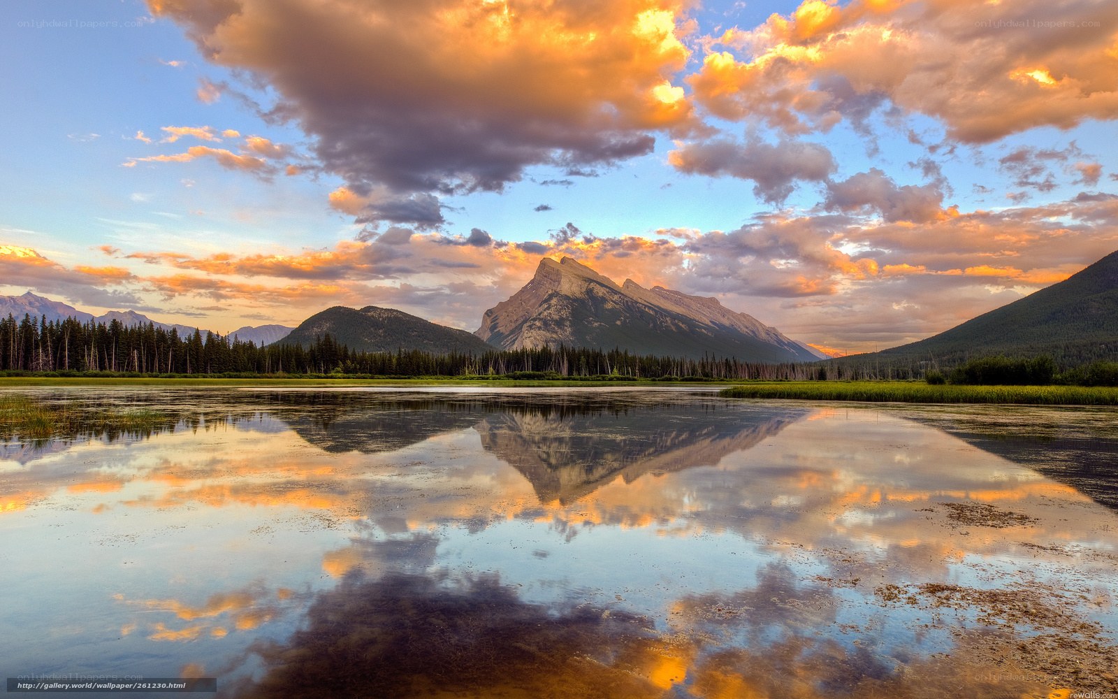 Mountain sunset over a calm lake