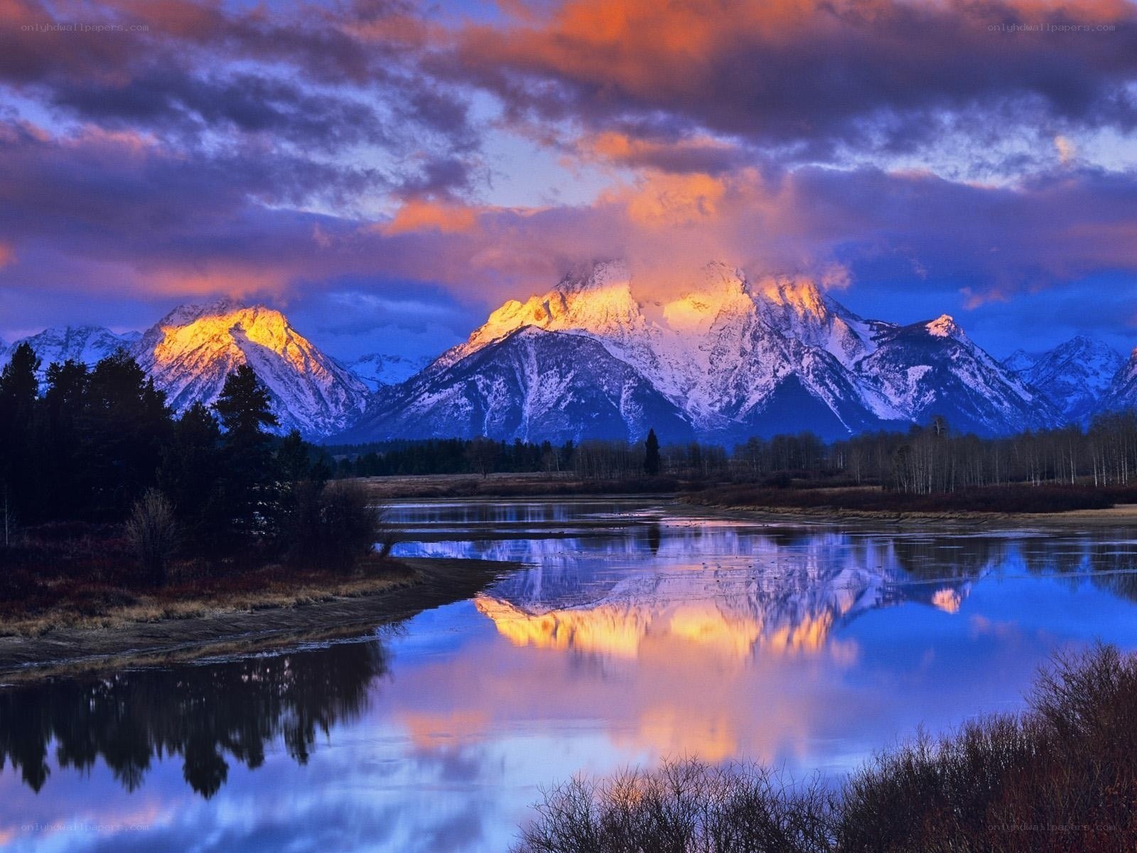 Mountain sunset over a calm river