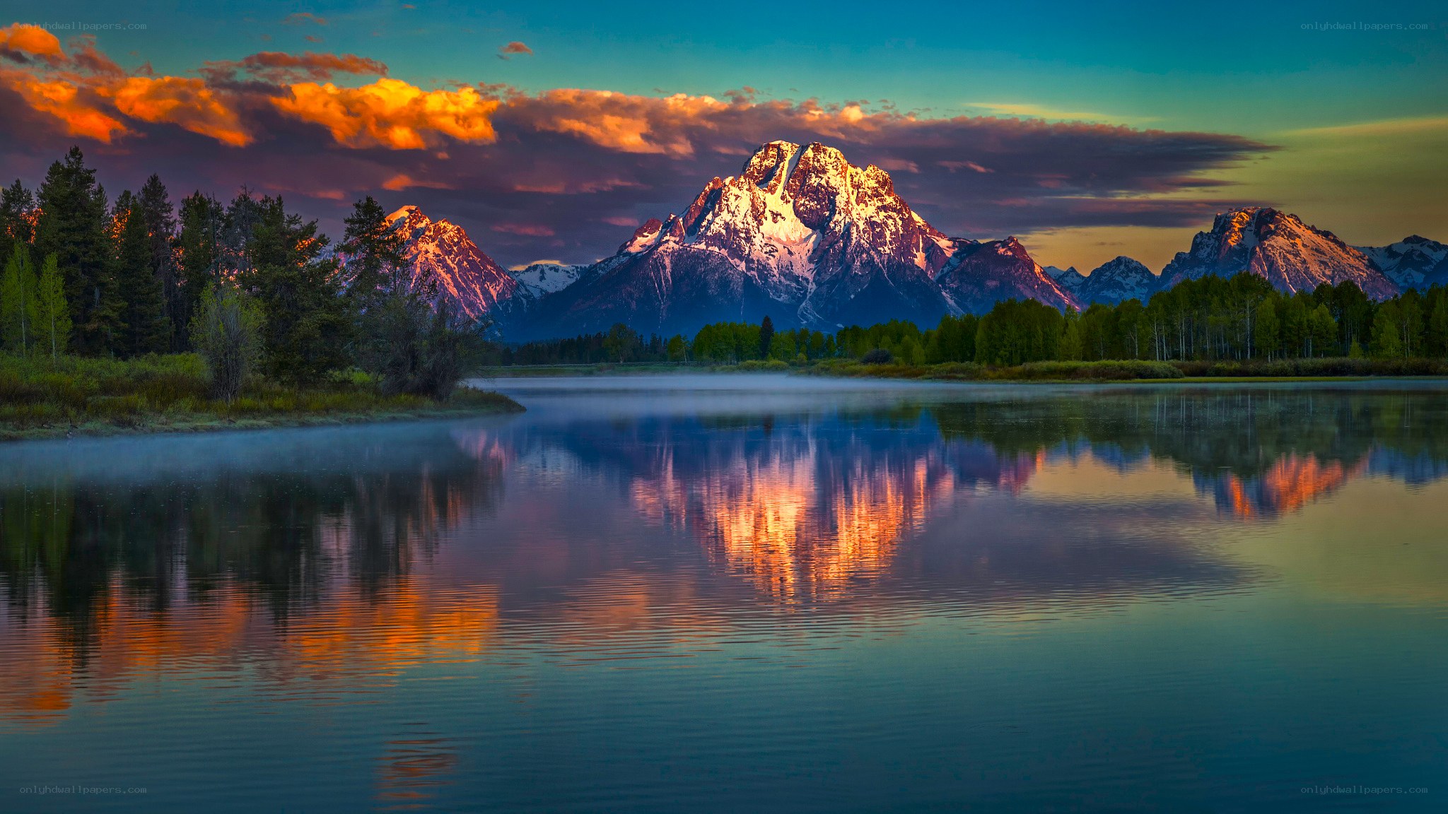Mountain sunset over calm lake