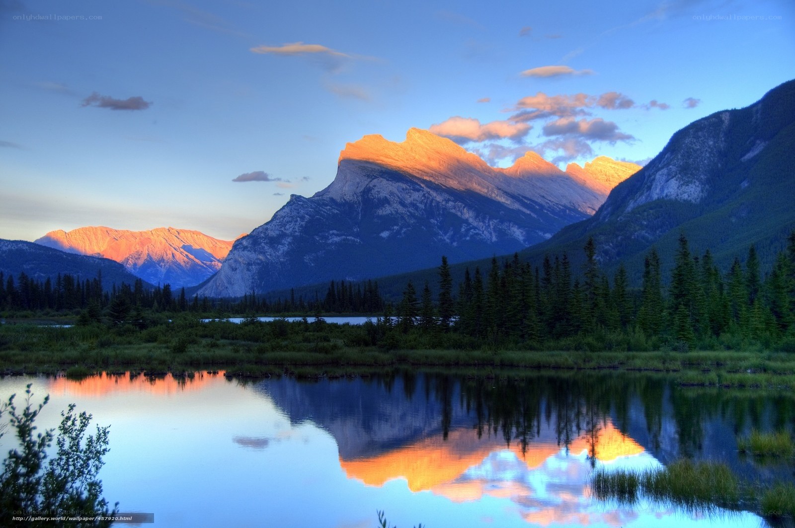 Mountain sunset over calm lake