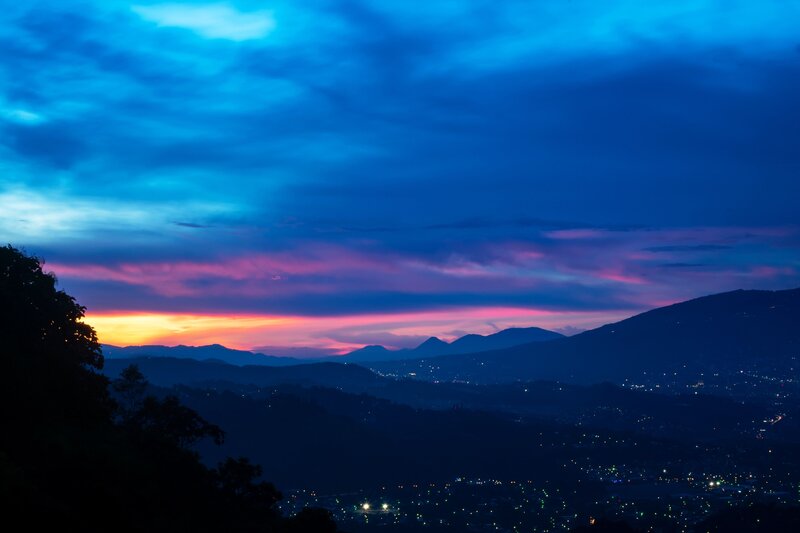Mountain sunset over city