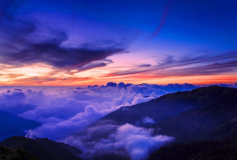 Mountain sunset over clouds