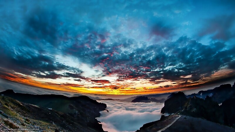 Mountain sunset over clouds