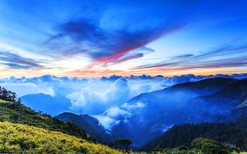 Mountain sunset over clouds