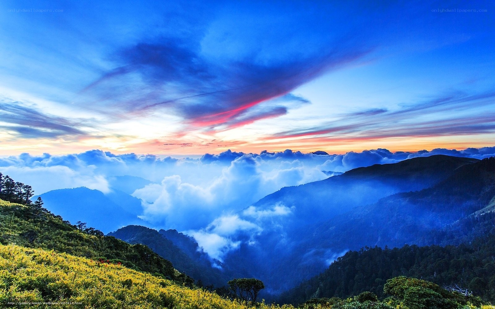 Mountain sunset over clouds