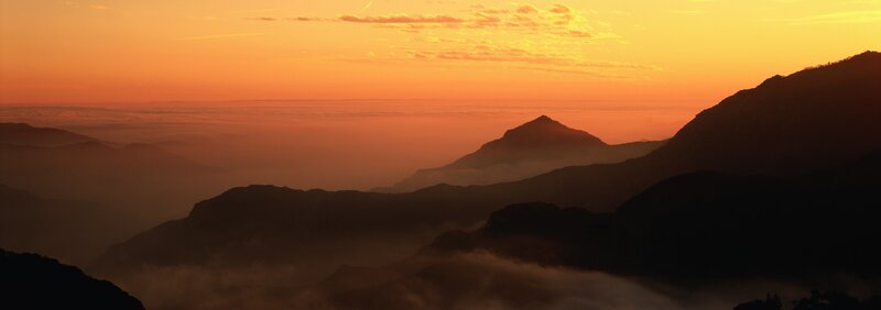 mountain sunset over clouds