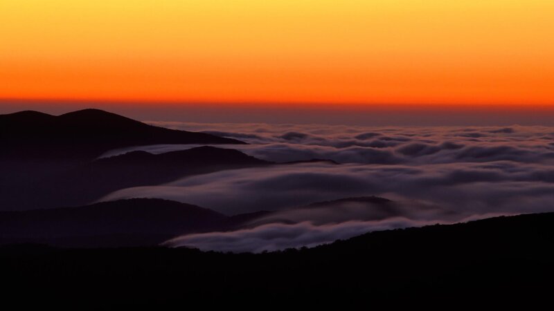 mountain sunset over clouds
