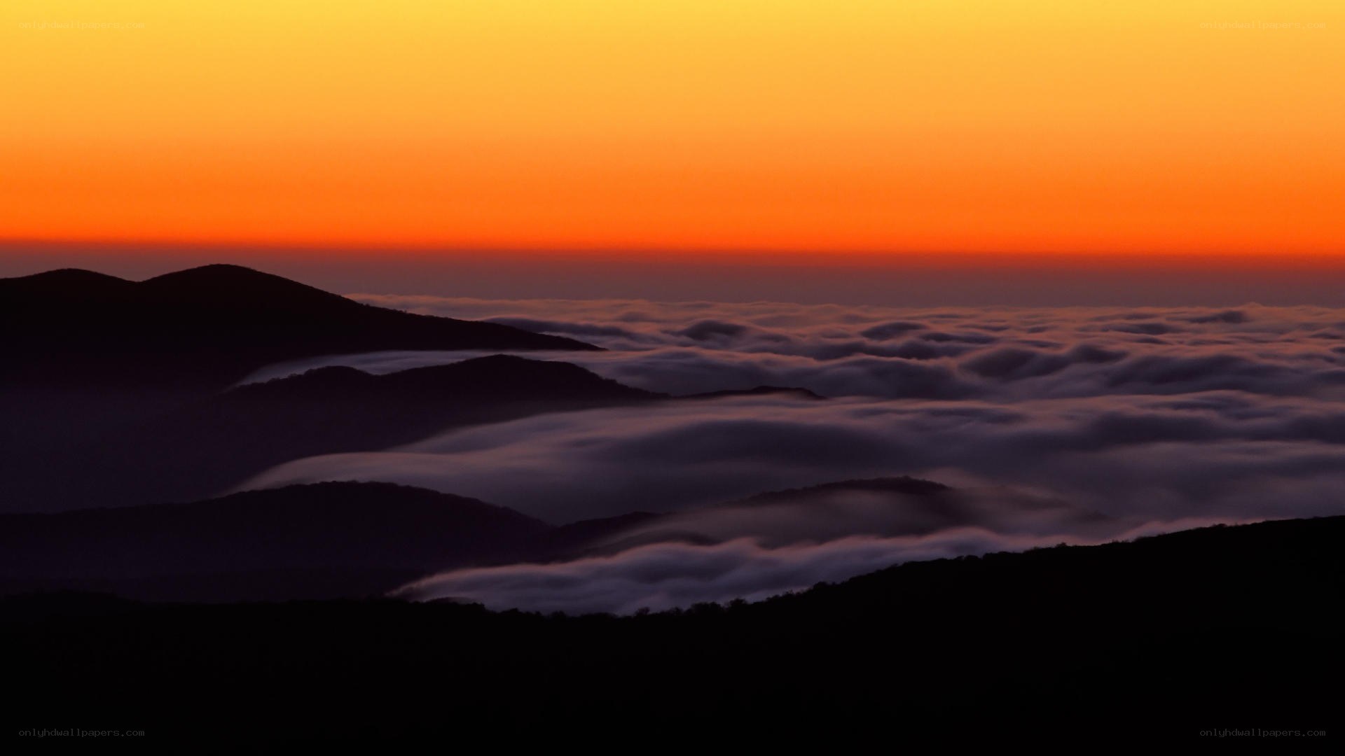 mountain sunset over clouds