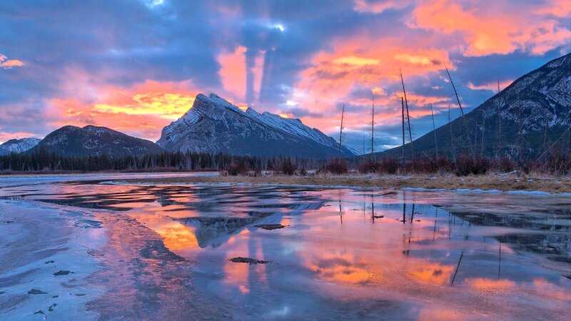 Mountain sunset over frozen lake