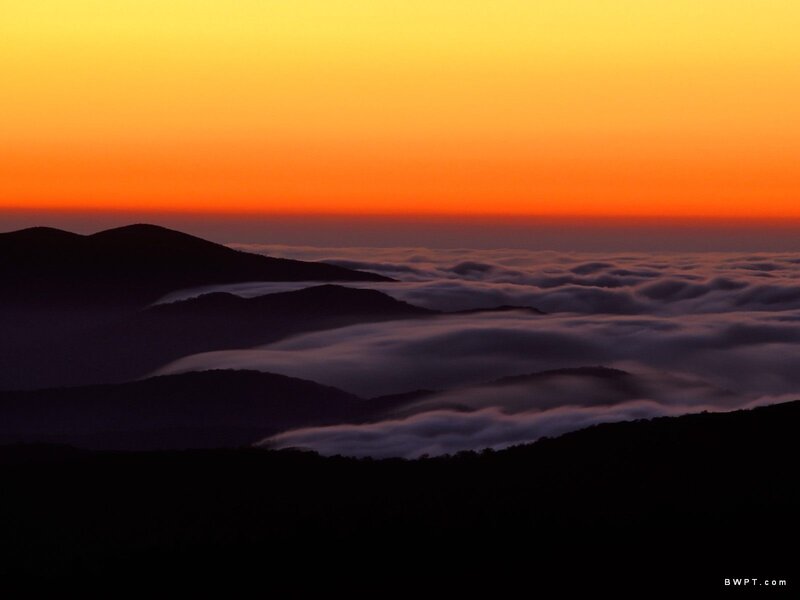 Mountain sunset over sea of clouds