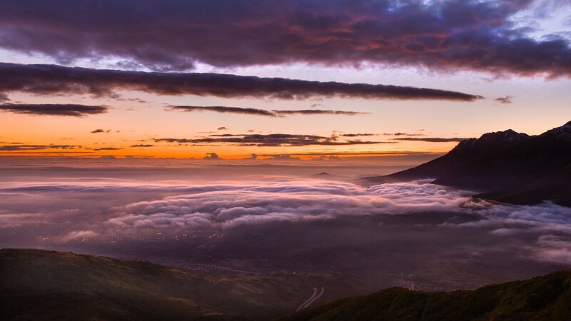 Mountain sunset over sea of clouds