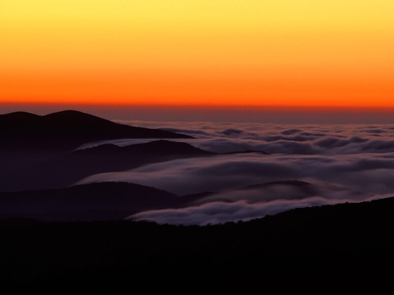 Mountain sunset over sea of clouds