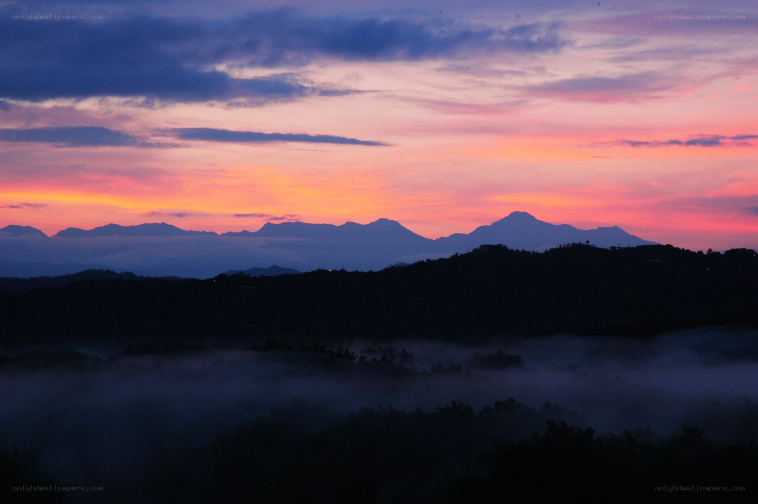 Mountain sunset with fog