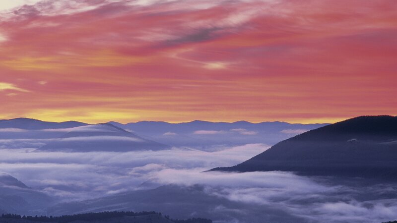 Mountain sunset with fog