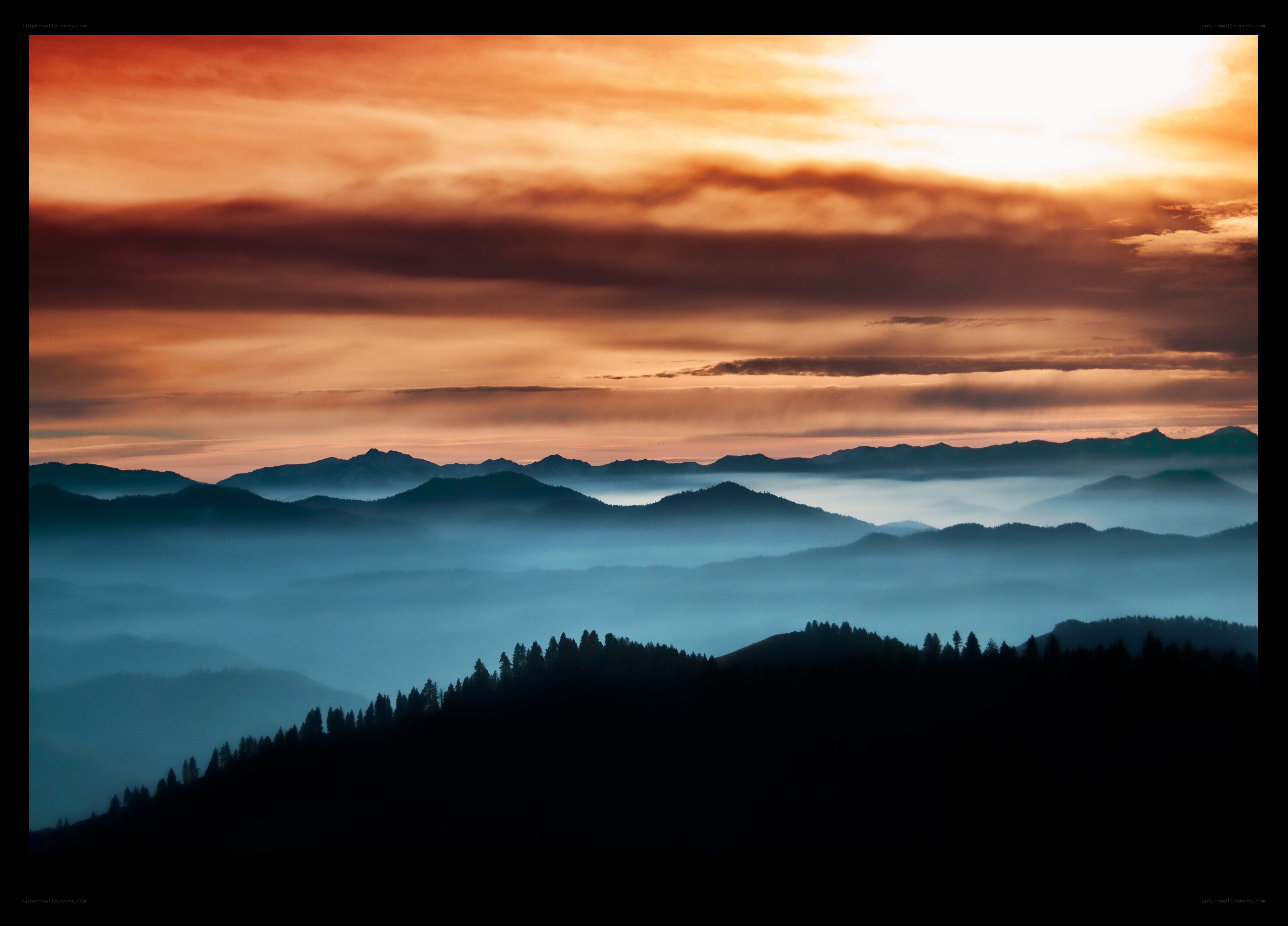 Mountain sunset with fog layers