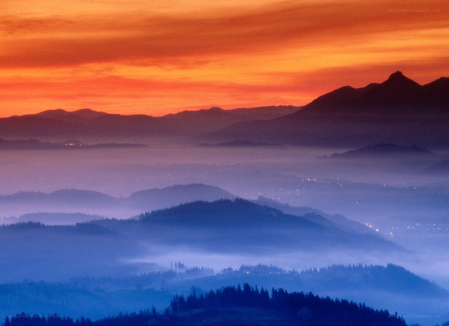 Mountain sunset with fog layers