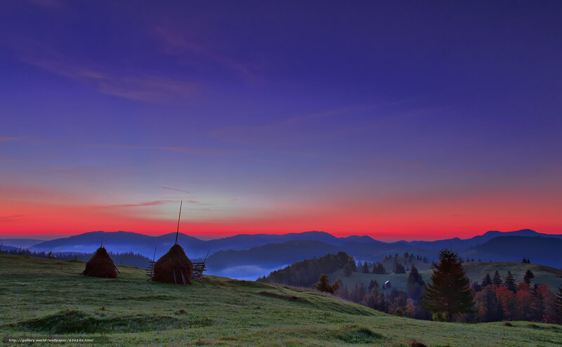 Mountain sunset with hay bales