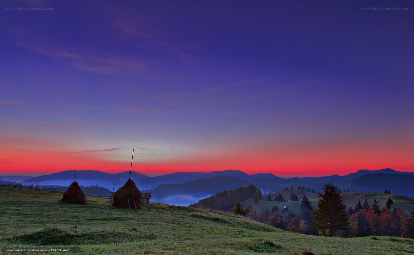 Mountain sunset with hay bales