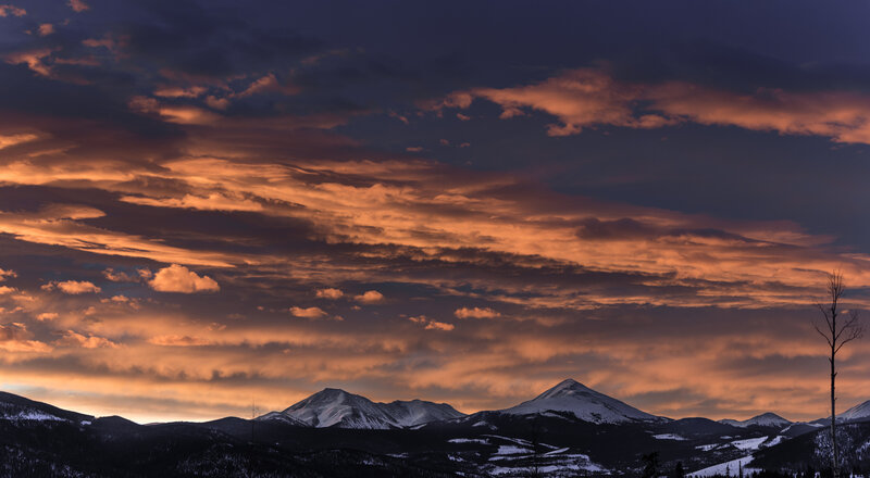 Mountain sunset with orange clouds