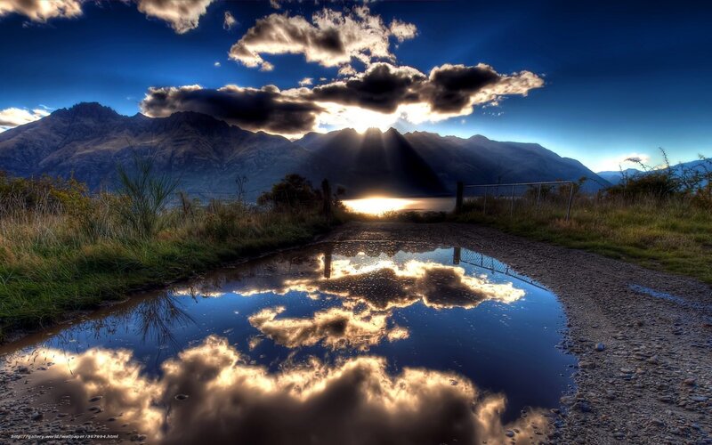 Mountain sunset with puddle reflection