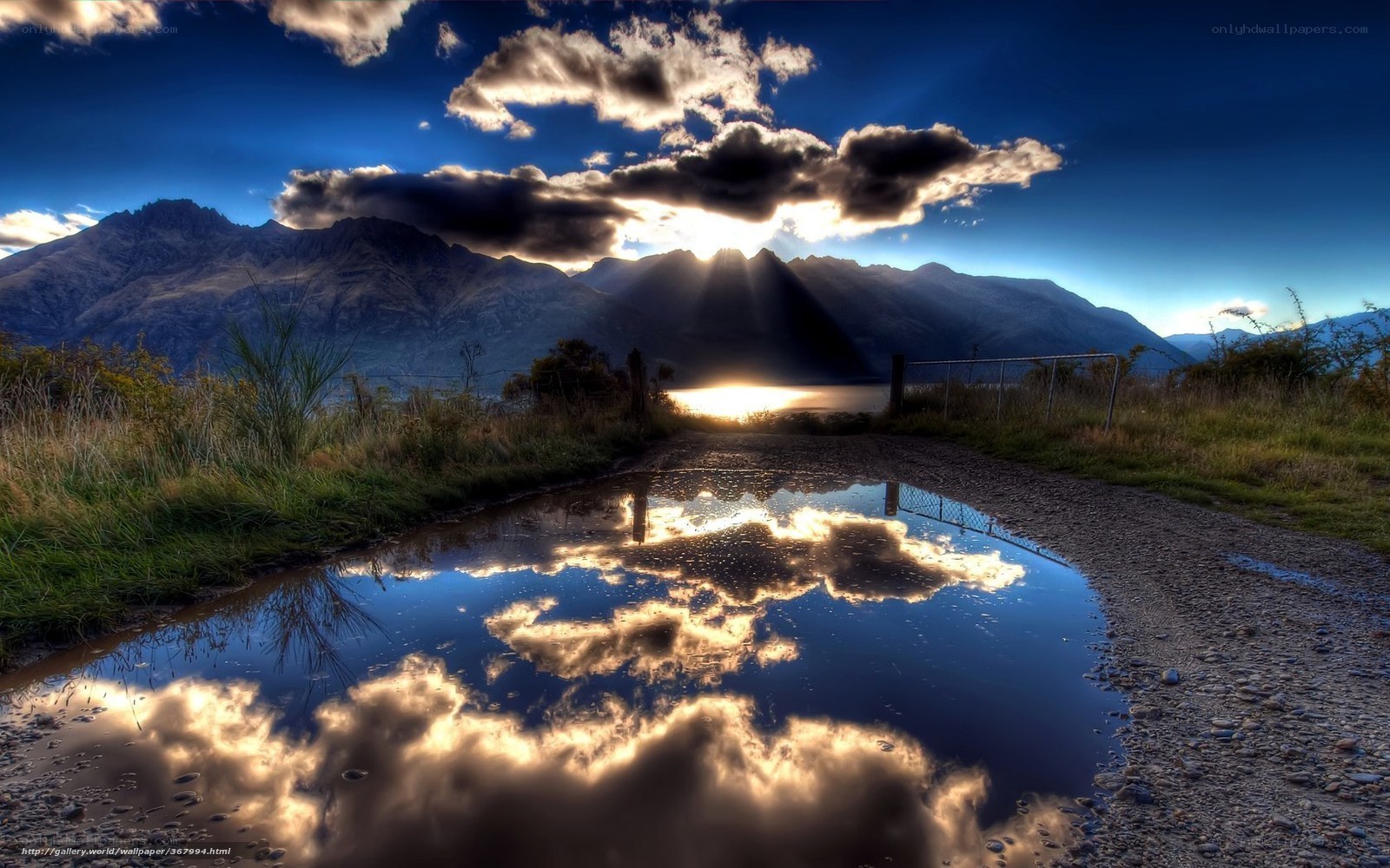 Mountain sunset with puddle reflection